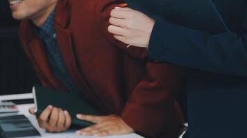 Financial analysts analyze business financial reports on a digital tablet planning investment project during a discussion at a meeting of corporate showing the results of their successful teamwork. video