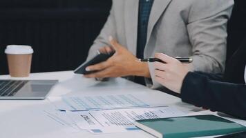 Financial analysts analyze business financial reports on a digital tablet planning investment project during a discussion at a meeting of corporate showing the results of their successful teamwork. video