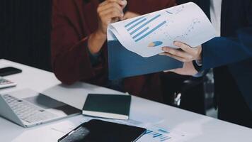 Financial analysts analyze business financial reports on a digital tablet planning investment project during a discussion at a meeting of corporate showing the results of their successful teamwork. video