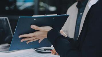 Financial analysts analyze business financial reports on a digital tablet planning investment project during a discussion at a meeting of corporate showing the results of their successful teamwork. video