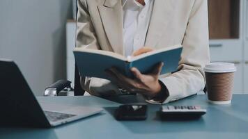 Young architect work project. Photo woman working with new startup project in modern loft. Generic design notebook on wood table. Horizontal, film effect video