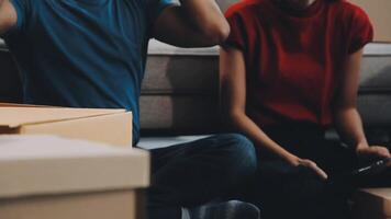 A couple of men and women talking while packing things into cardboard boxes video