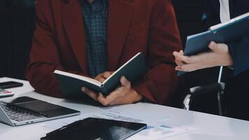 Financial analysts analyze business financial reports on a digital tablet planning investment project during a discussion at a meeting of corporate showing the results of their successful teamwork. video