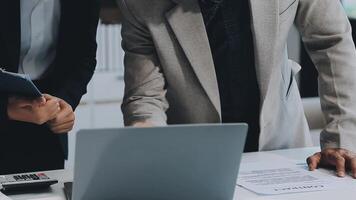 Financial analysts analyze business financial reports on a digital tablet planning investment project during a discussion at a meeting of corporate showing the results of their successful teamwork. video