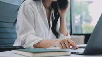 mujer de negocios asiática con traje formal en la oficina feliz y alegre durante el uso del teléfono inteligente y el trabajo video