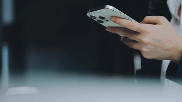 Asian businesswoman in formal suit in office happy and cheerful during using smartphone and working video