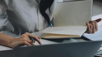 Young architect work project. Photo woman working with new startup project in modern loft. Generic design notebook on wood table. Horizontal, film effect video