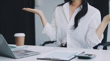 Asian businesswoman in formal suit in office happy and cheerful during using smartphone and working video