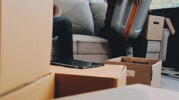 A couple of men and women talking while packing things into cardboard boxes video