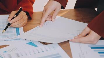 Financial analysts analyze business financial reports on a digital tablet planning investment project during a discussion at a meeting of corporate showing the results of their successful teamwork. video