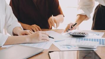 Financial analysts analyze business financial reports on a digital tablet planning investment project during a discussion at a meeting of corporate showing the results of their successful teamwork. video