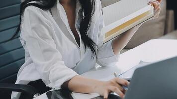 Young architect work project. Photo woman working with new startup project in modern loft. Generic design notebook on wood table. Horizontal, film effect video