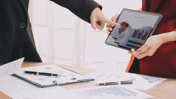 Financial analysts analyze business financial reports on a digital tablet planning investment project during a discussion at a meeting of corporate showing the results of their successful teamwork. video