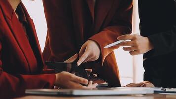 Financial analysts analyze business financial reports on a digital tablet planning investment project during a discussion at a meeting of corporate showing the results of their successful teamwork. video