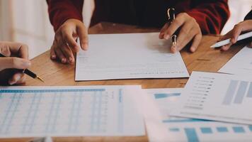 Financial analysts analyze business financial reports on a digital tablet planning investment project during a discussion at a meeting of corporate showing the results of their successful teamwork. video