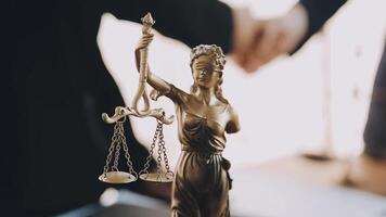 Lawyer shaking hands with a client making about documents, contracts, agreements, cooperation agreements with a female client at the lawyer's desk and a hammer at the table. video