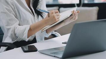 Young architect work project. Photo woman working with new startup project in modern loft. Generic design notebook on wood table. Horizontal, film effect video