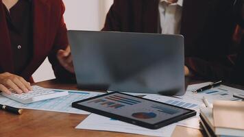 Financial analysts analyze business financial reports on a digital tablet planning investment project during a discussion at a meeting of corporate showing the results of their successful teamwork. video