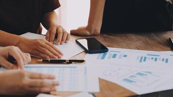 Financial analysts analyze business financial reports on a digital tablet planning investment project during a discussion at a meeting of corporate showing the results of their successful teamwork. video