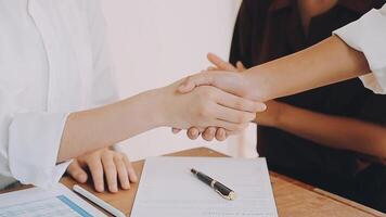 Business people shaking hands, finishing up meeting video