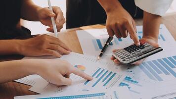 Financial analysts analyze business financial reports on a digital tablet planning investment project during a discussion at a meeting of corporate showing the results of their successful teamwork. video