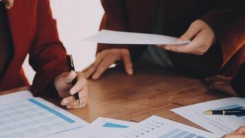 Financial analysts analyze business financial reports on a digital tablet planning investment project during a discussion at a meeting of corporate showing the results of their successful teamwork. video