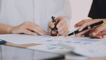 Financial analysts analyze business financial reports on a digital tablet planning investment project during a discussion at a meeting of corporate showing the results of their successful teamwork. video