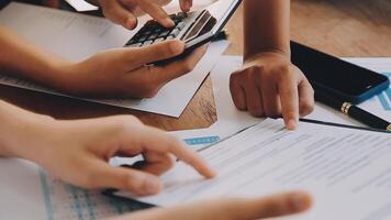 Financial analysts analyze business financial reports on a digital tablet planning investment project during a discussion at a meeting of corporate showing the results of their successful teamwork. video