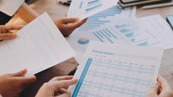 Financial analysts analyze business financial reports on a digital tablet planning investment project during a discussion at a meeting of corporate showing the results of their successful teamwork. video