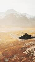 slow motion Vietnam War era helicopter in mountains video