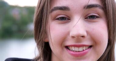 Portrait of happy caucasian girl looking at camera and smiling. Spending quality time at home. video