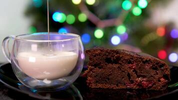 frothing milk with cappuccino maker in glass mug Brownie cake with cherries Christmas tree, drops of milk splashes, delicious delicacy, preparation of cocoa, hot chocolate, coffee, for Christmas video