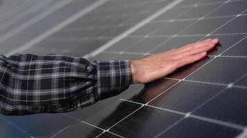 Close up of an young engineer hand is checking an operation of sun and cleanliness of photovoltaic solar panels on a sunset. Concept. renewable energy, technology, electricity, service, green, future video