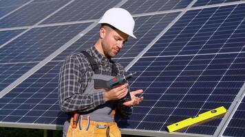 Male engineer preparing tools for installing solar panels video