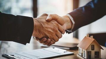 Realtor and buyer shaking hands. Successful real estate transaction. Close-up. photo