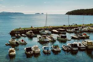 Amazing view of Dubrovnik and the boat in a marina on a sunny day. Travel destination in Croatia. photo