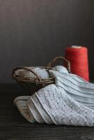 Grey knitting with red yarn in a basket. photo