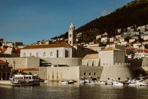 Amazing view of Dubrovnik and the boat in a marina on a sunny day. photo