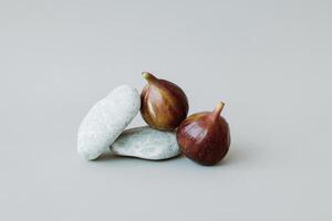 Ripe figs on a grey background. Minimal concept. photo