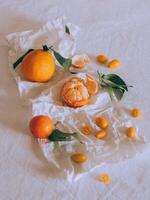 Ripe citrus fruits on a white craft paper. Minimal concept photo