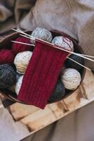 Hand knitted socks with needles and yarn ball. Concept for handmade and hygge slow life. photo