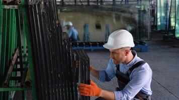 Professional man worker in a window warehouse prepares windows for sending video