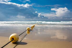 Mediterranean beach with yellow buoys. photo