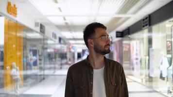 Handsome young man walking in mall video