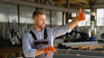 Serious manager in uniform giving commands to workers on industrial warehouse. Bearded man gesturing and shouting during working process video