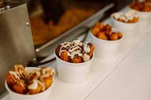 Delicious churros with cream and chocolate in a street cafe. photo