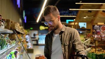 Man shopping cheese in grocery store video