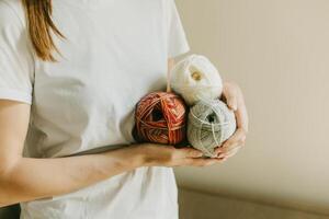 Girl with yarn skeins in a hands for knitting. photo