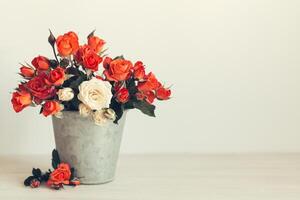 Romantic bouquet of bright roses in a vintage pot. Background or postcard. Place for text. photo