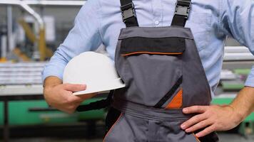 Close up of worker is standing with helmet at industry factory video